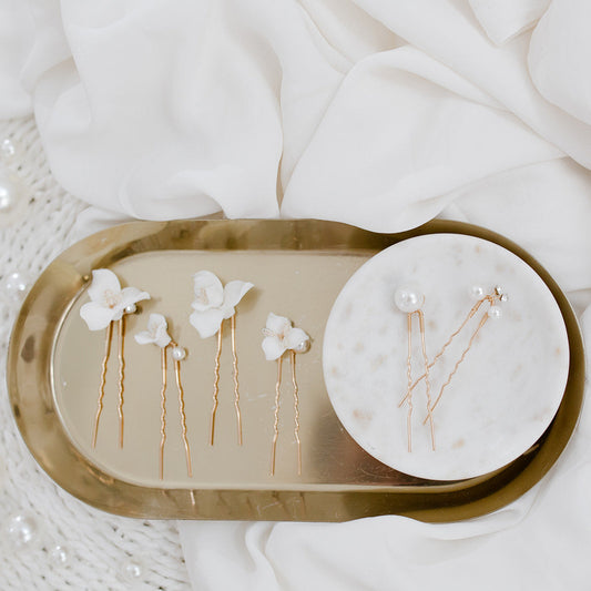 Ceramic floral bridal hair pins with pearl details.
