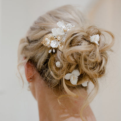 Ceramic floral bridal hair pins with pearl details.