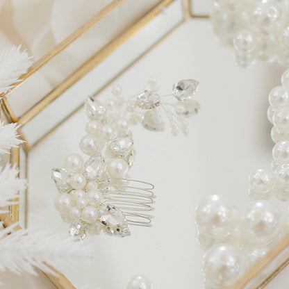Pearl and crystal bridal comb featuring clustered ivory pearls and clear bead detailing for an elegant, organic finish.