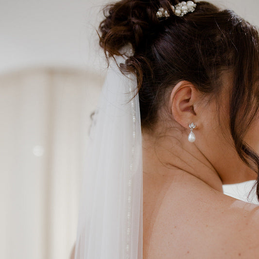 Stunning single tier fingertip veil with pearl and crystal edging.