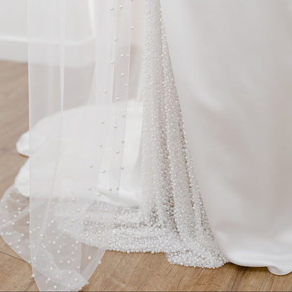 Sheer single tier bridal veil adorned with scattered ivory pearls along the edge.