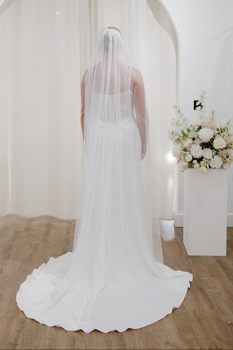 Sheer single tier bridal veil adorned with scattered ivory pearls along the edge.