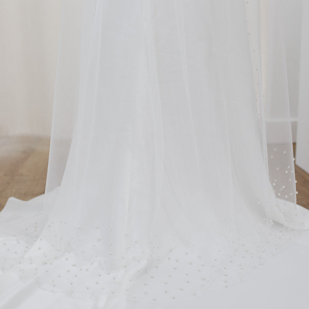 Sheer single tier bridal veil adorned with scattered ivory pearls along the edge.