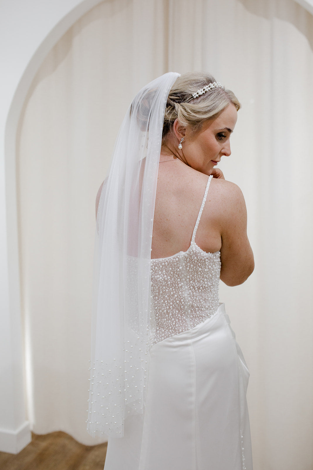Sheer single tier bridal veil adorned with scattered ivory pearls along the edge.