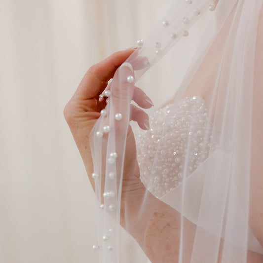 Sheer single tier bridal veil adorned with scattered ivory pearls along the edge.