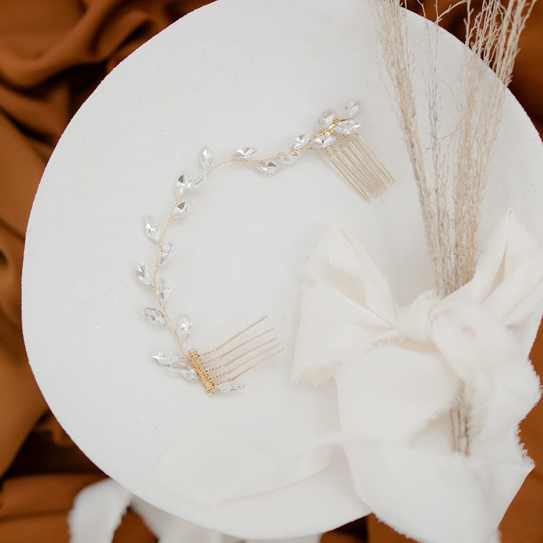 Hair accessories on a white circular stand with a brown fabric background